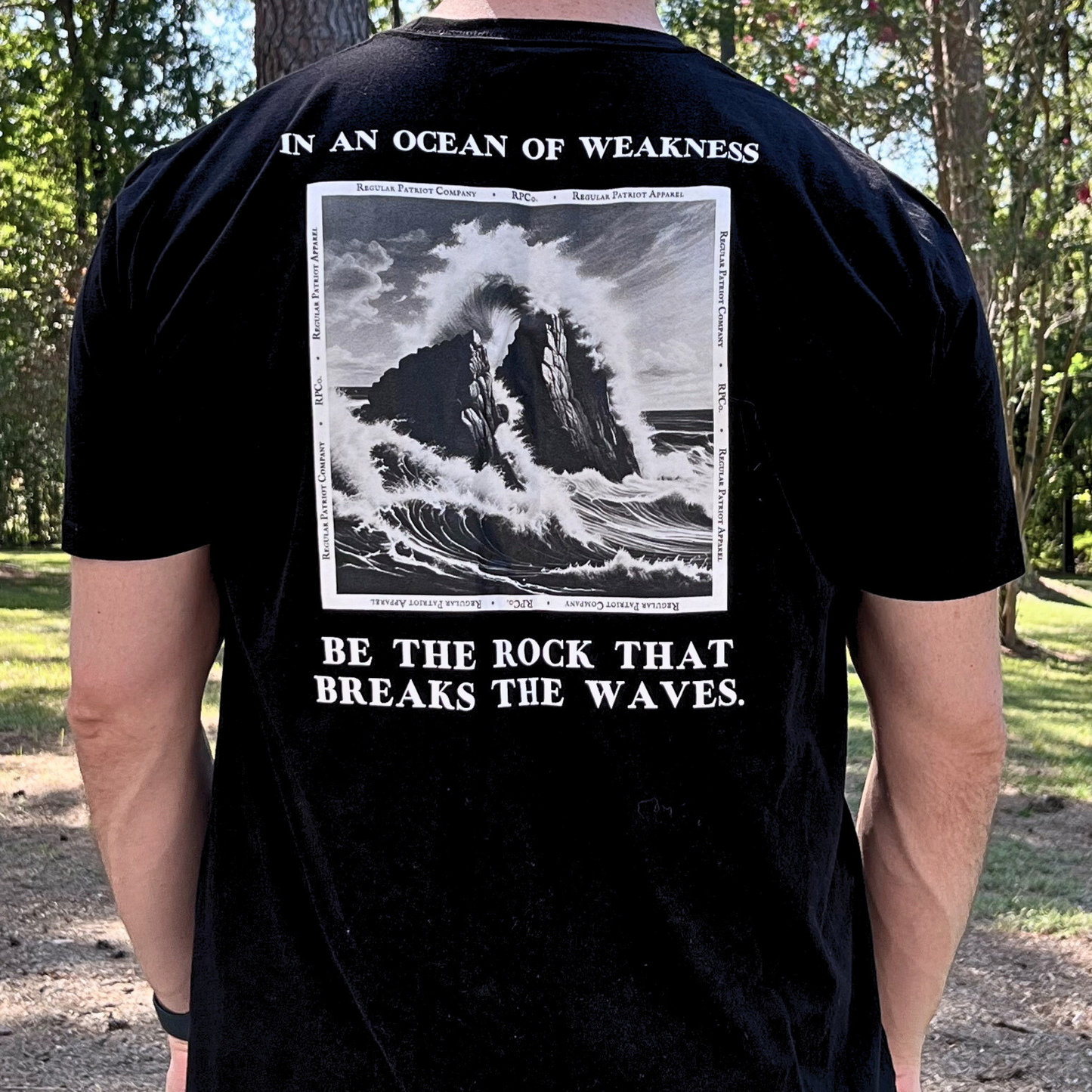 weakness and strength t-shirt. black, wearing outside back